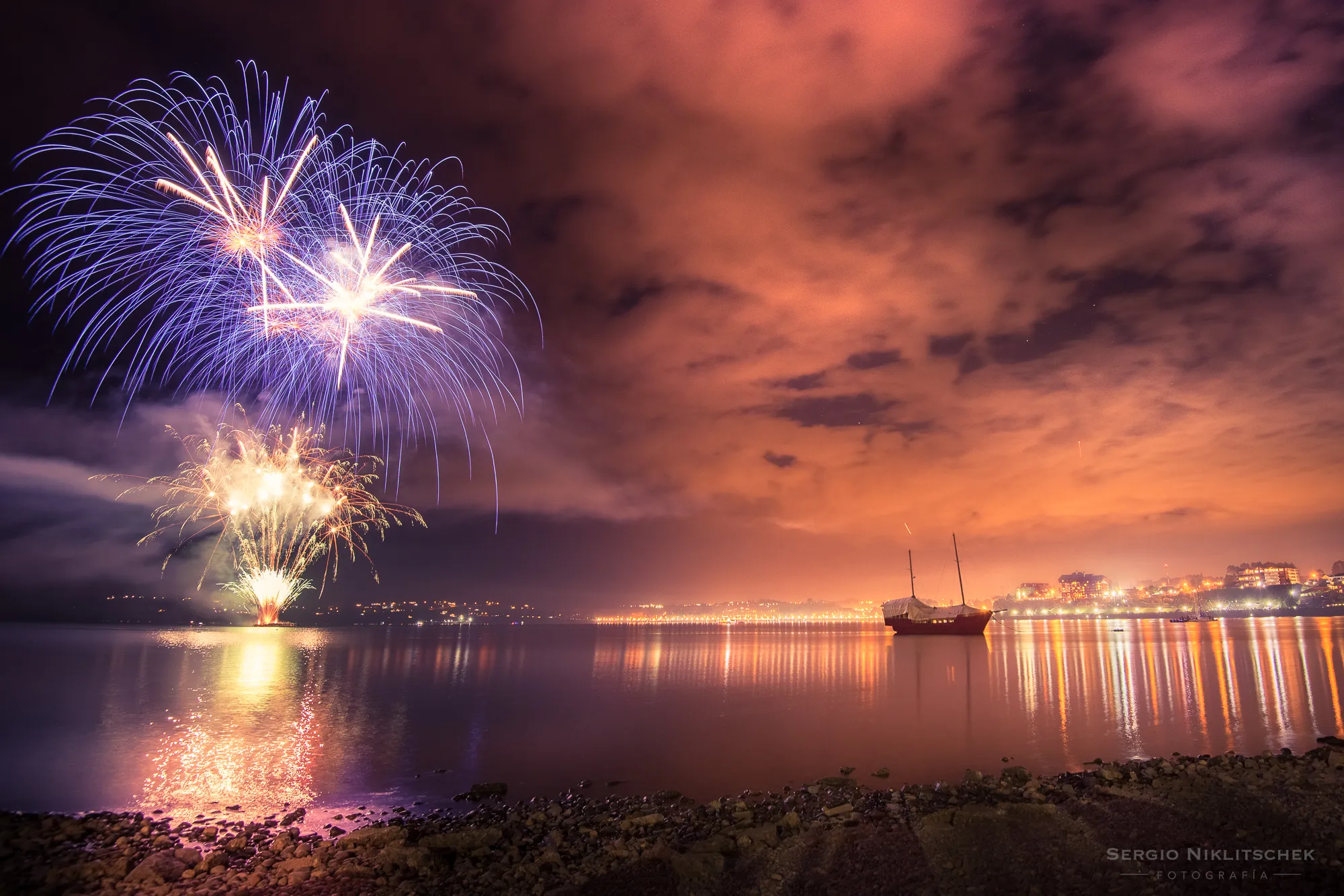 Fuegos artificiales de Año Nuevo sobre el lago Llanquihue, frente a la costanera de Puerto Varas
